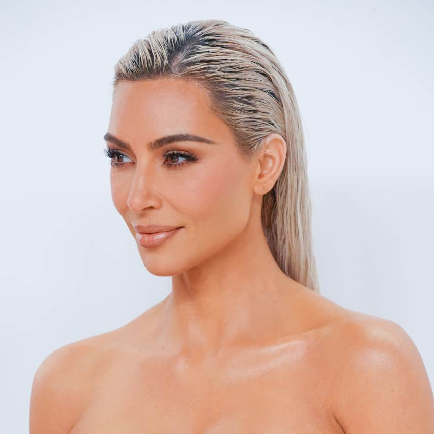 Kim Kardashian with blonde hair and slight grin