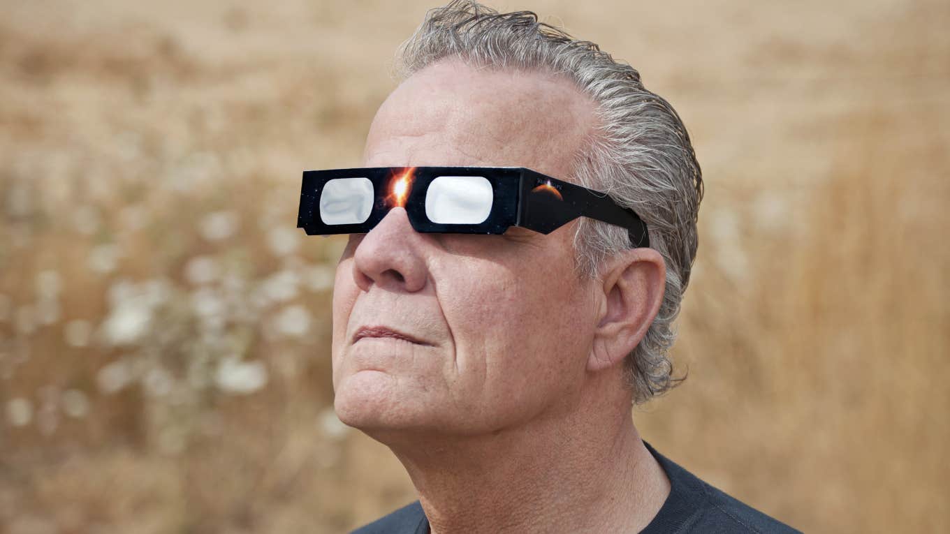 man wearing eclipse glasses 