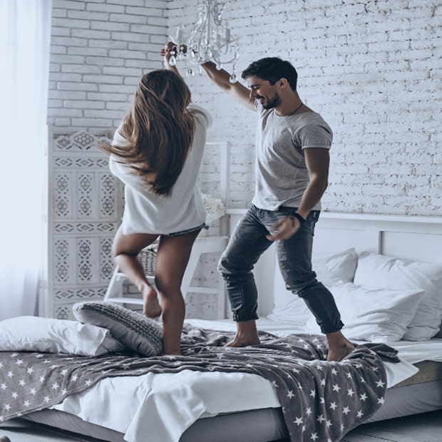 couple dancing on bed 