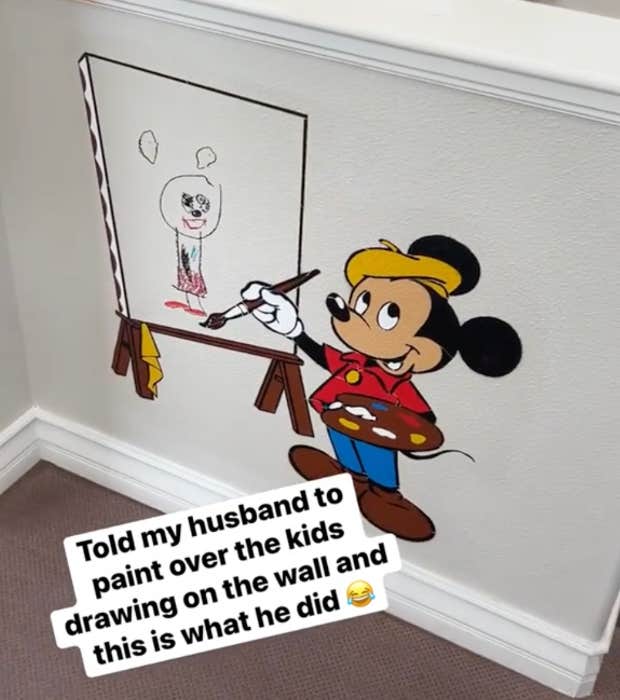 instead of painting over child&#039;s drawing on the wall, dad showcases it with mickey mouse painting on an easel