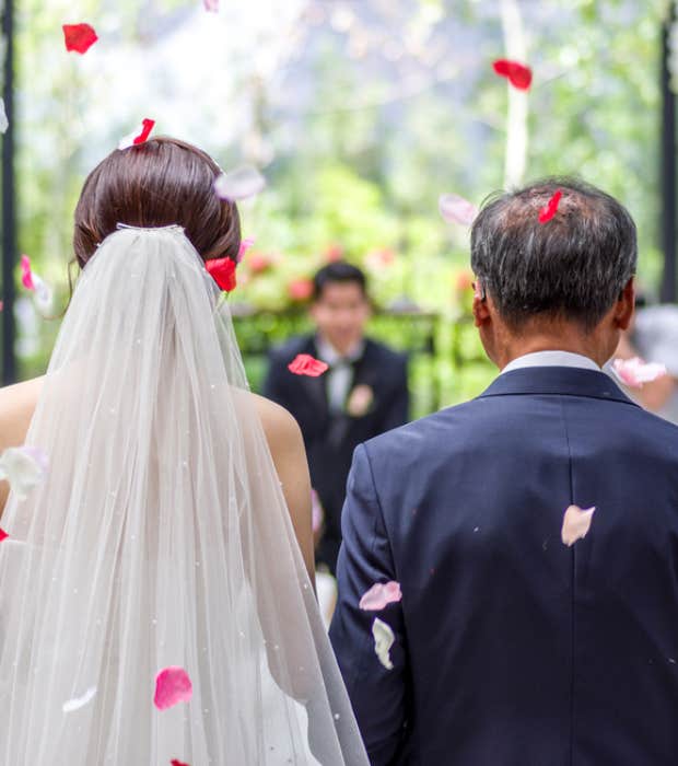 father walking daughter down the aisle in wedding ceremony