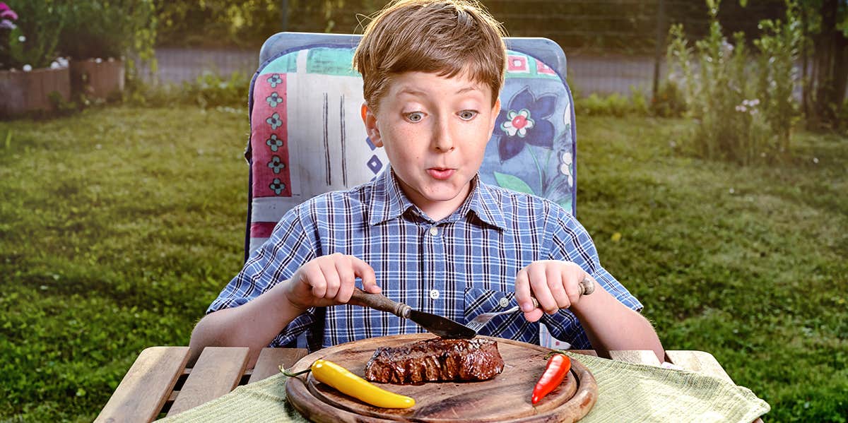 boy eating a steak