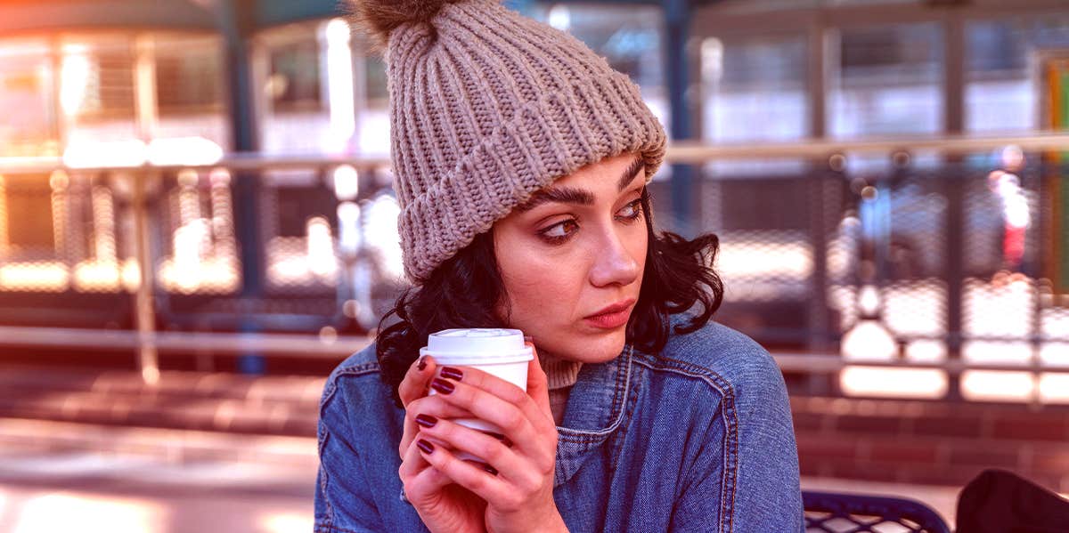 woman sitting outside with coffee