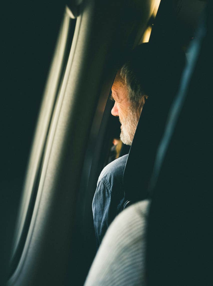 man thinking staring out plane window