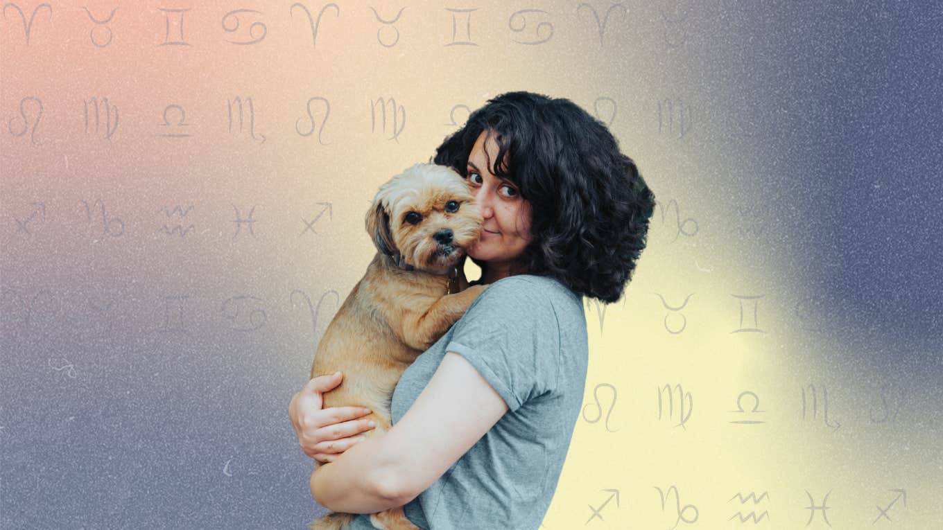 woman holding a small dog breed with zodiac signs