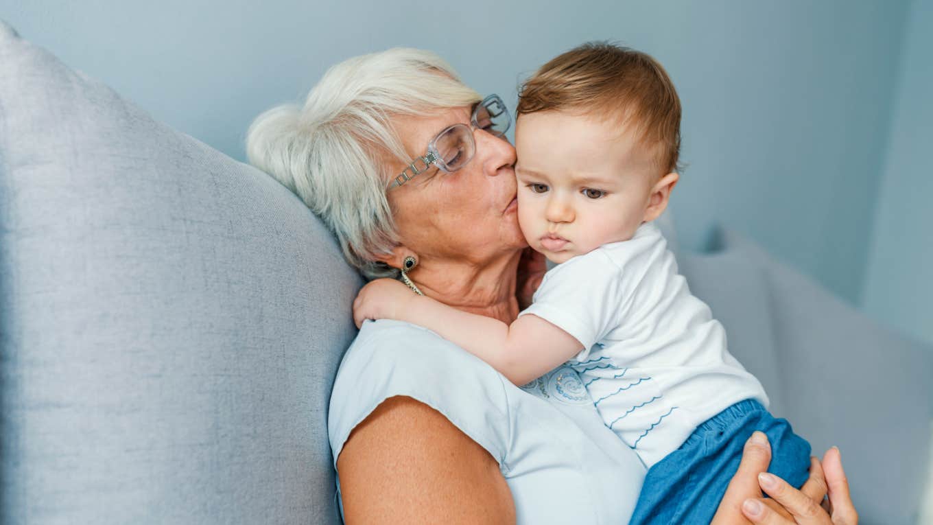 grandma kisses and holds her grandson