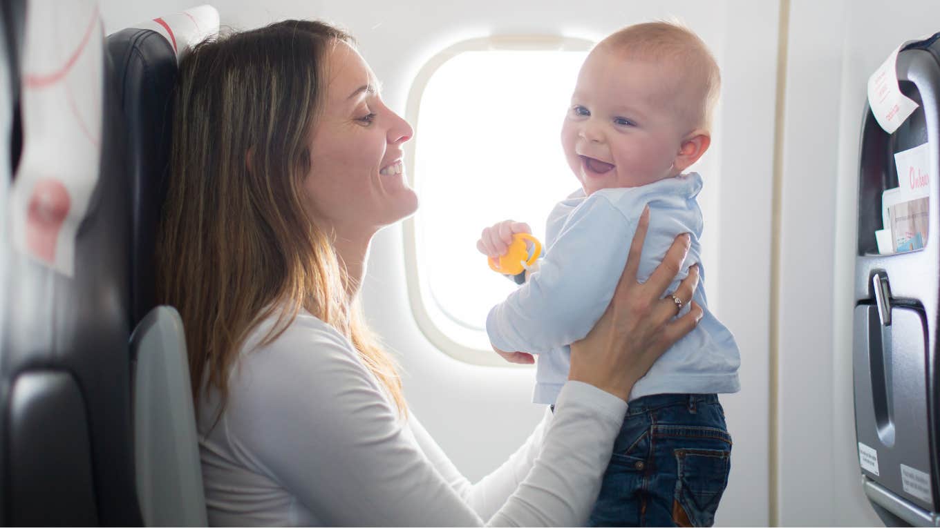 Mom holding her baby on an airplane