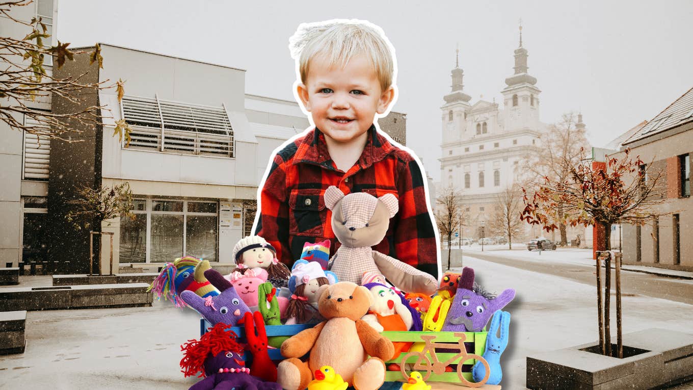 little boy behind a pile of toys, snowy cityscape