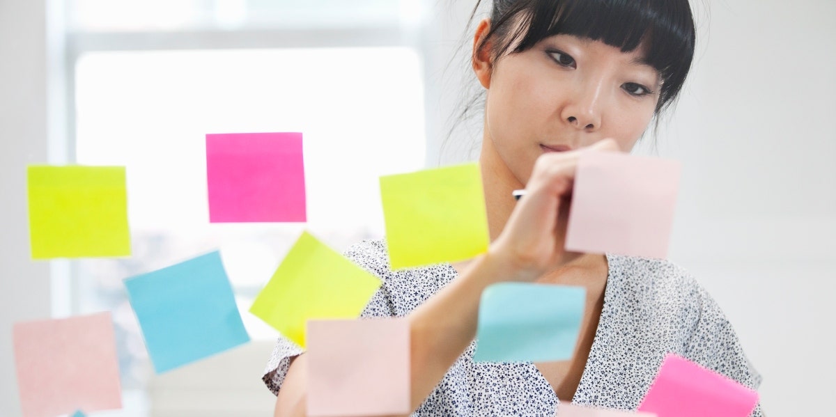 woman writing on post its