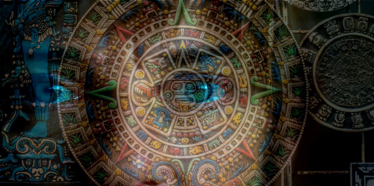 eyes peeking behind Maya calendar