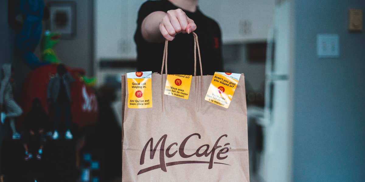 employee holding mcdonalds bag