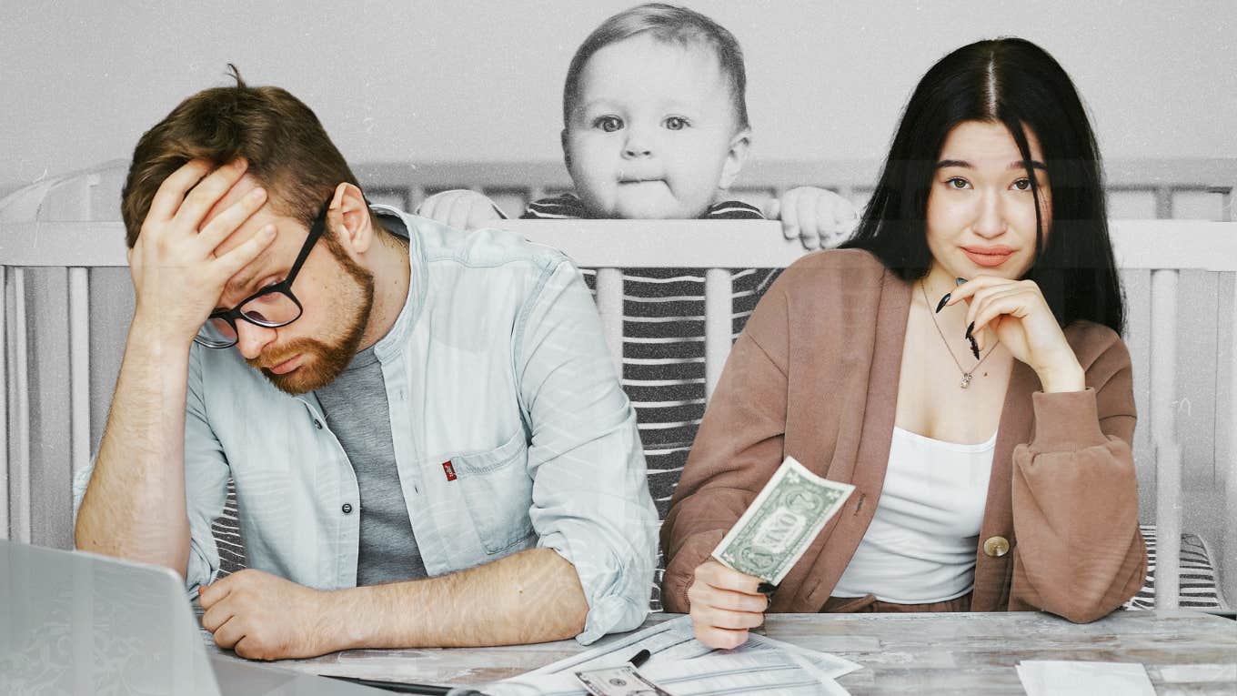 couple going over finances, baby looming in background