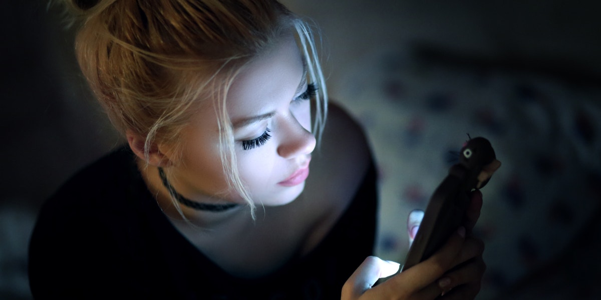 girl on phone in dark