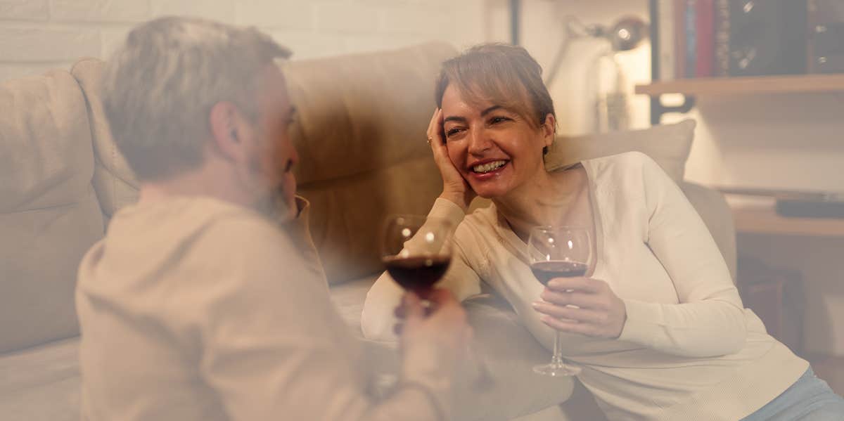 Man and woman drinking wine on couch