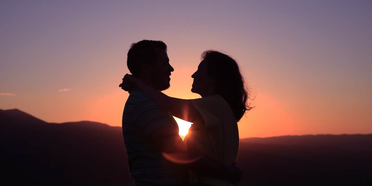 couple holding each other at sunset