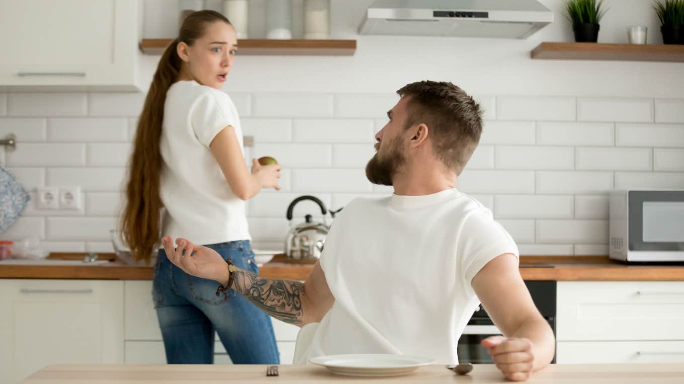 man argues with his wife in the kitchen