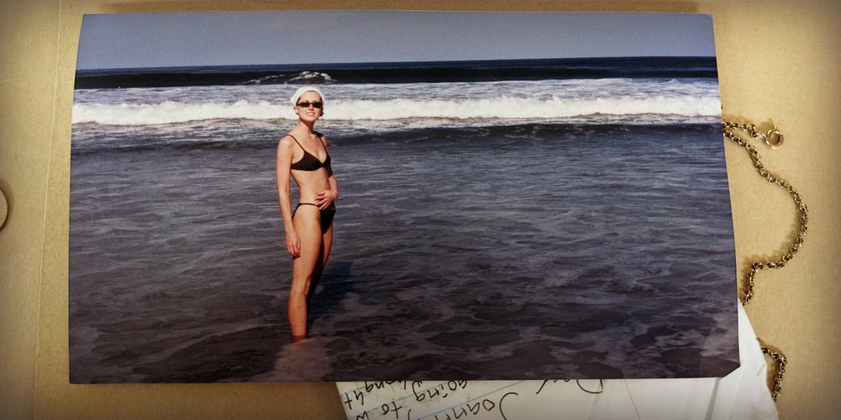 nostalgic collection of love letter, necklace and an old photograph of Joanna Schroeder in a swimsuit on a Florida beach