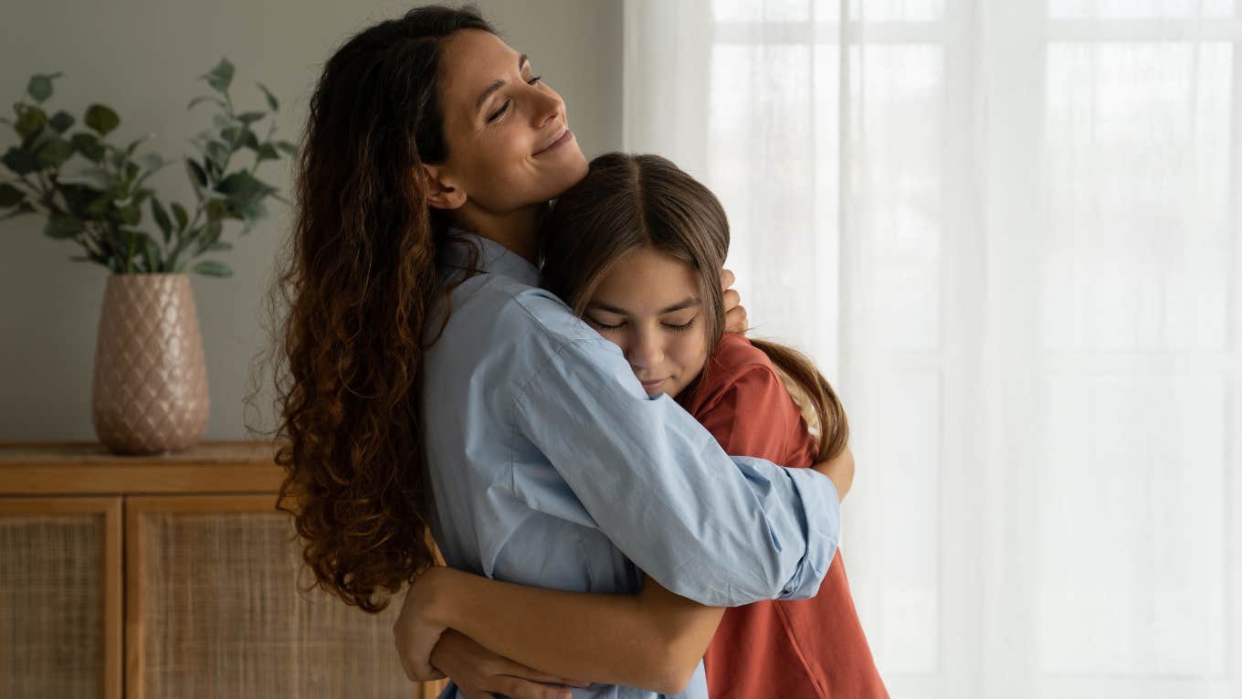 mother hugging her teenage daughter