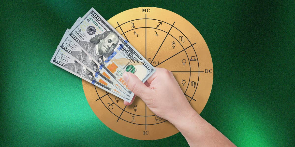 hand holding money in front of astrology house wheel