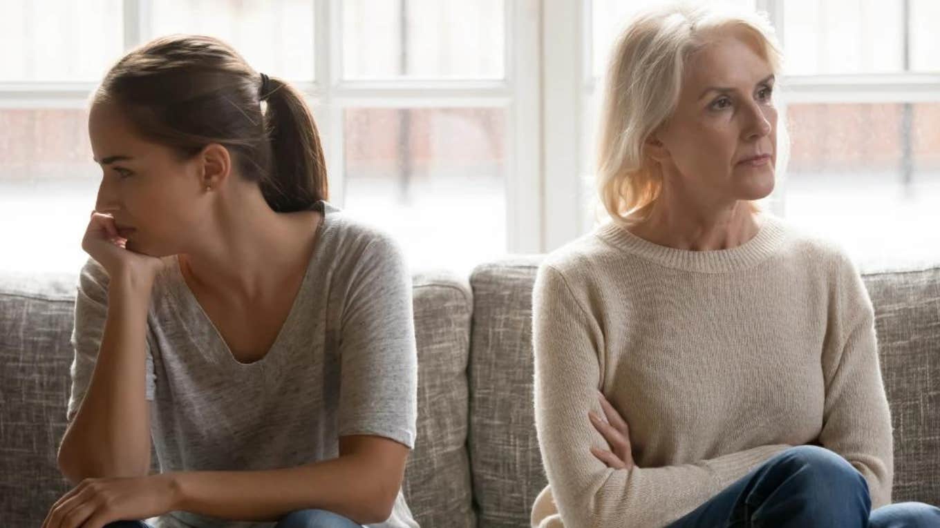 mother and daughter sitting on couch actively ignoring each other