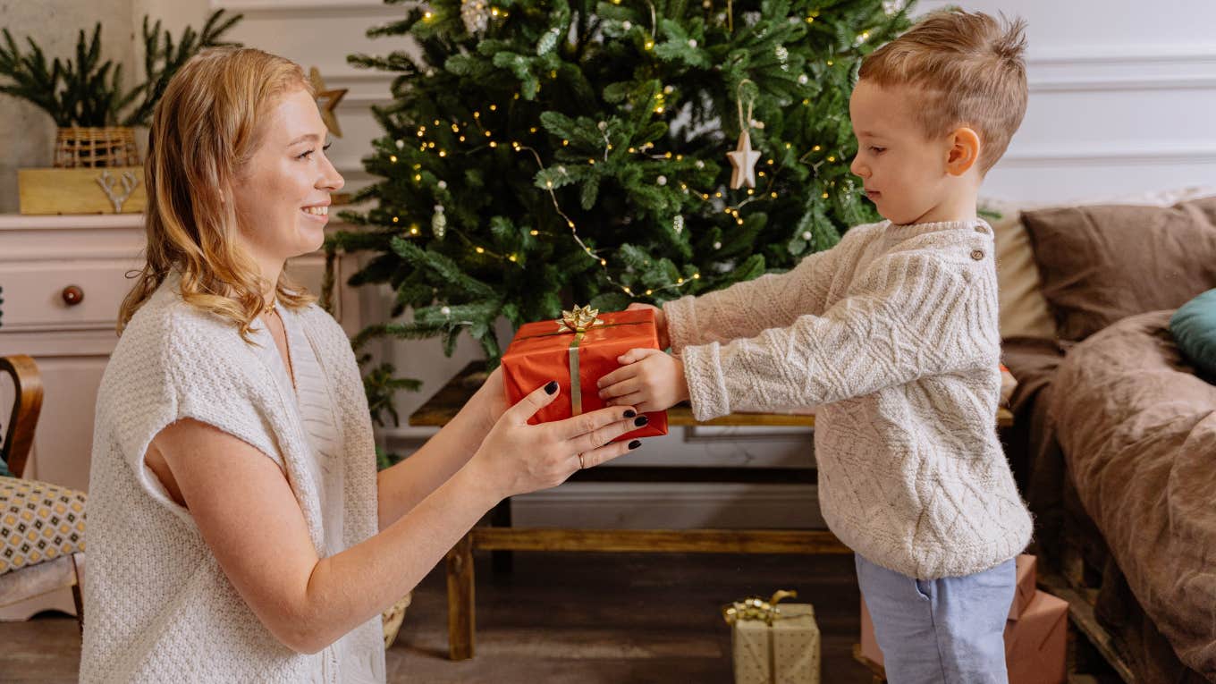 mom and child exchanging presents at Christmas 
