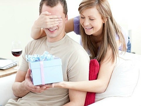 woman giving husband birthday present