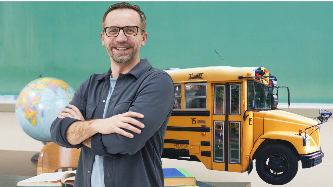 Teacher smiling with arms crossed in front of a yellow school bus. 