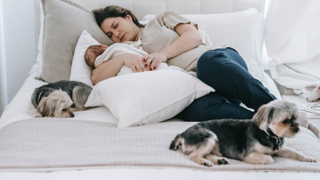 mom asleep with baby and dogs