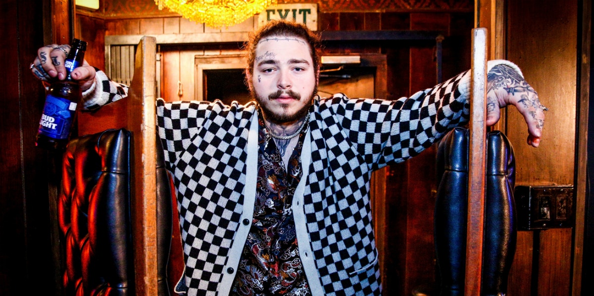Post Malone standing with beer
