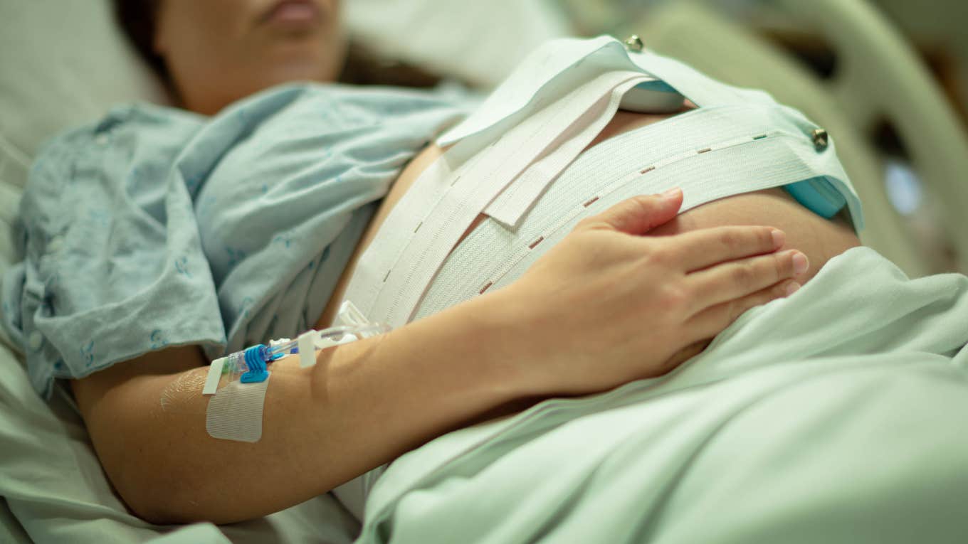 pregnant woman laying in hospital bed about to give birth