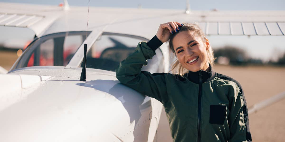 Woman posing with a plane