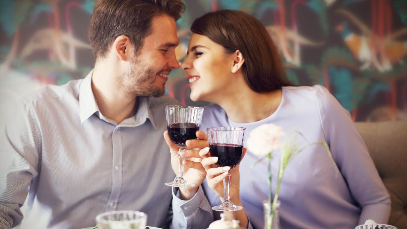 man and woman drinking wine romantic dinner