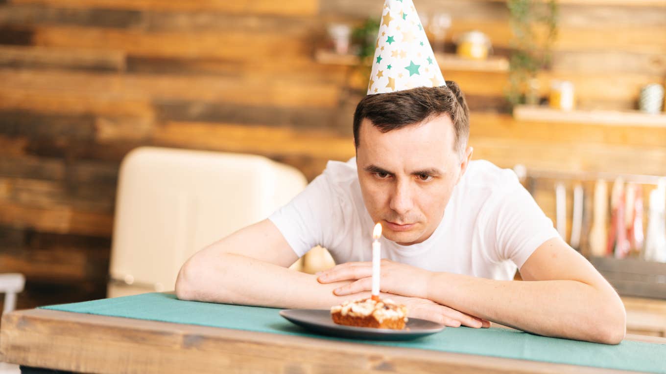man alone on birthday with cake