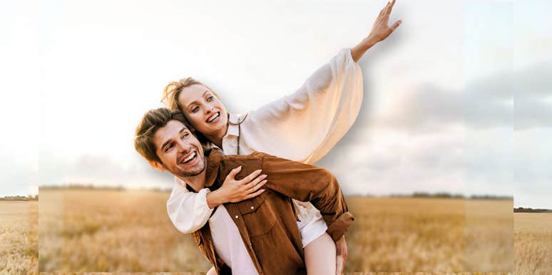 Couple being playful in the middle of a field 