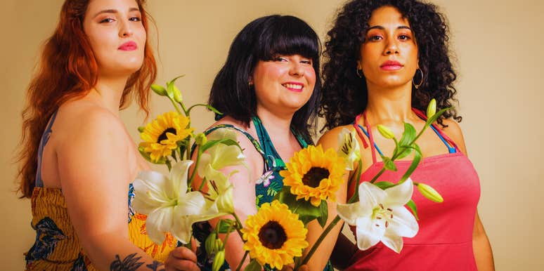 women with body positivity holding flowers