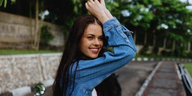 confident smiling woman in jean jacket