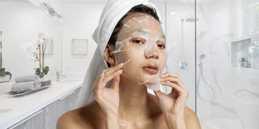 Woman putting on a face mask after showering. 