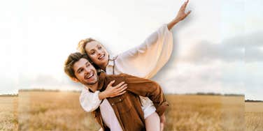 Couple being playful in the middle of a field 