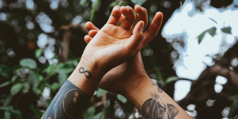 Photo of a Wrist with a Tattoo and a Bracelet · Free Stock Photo