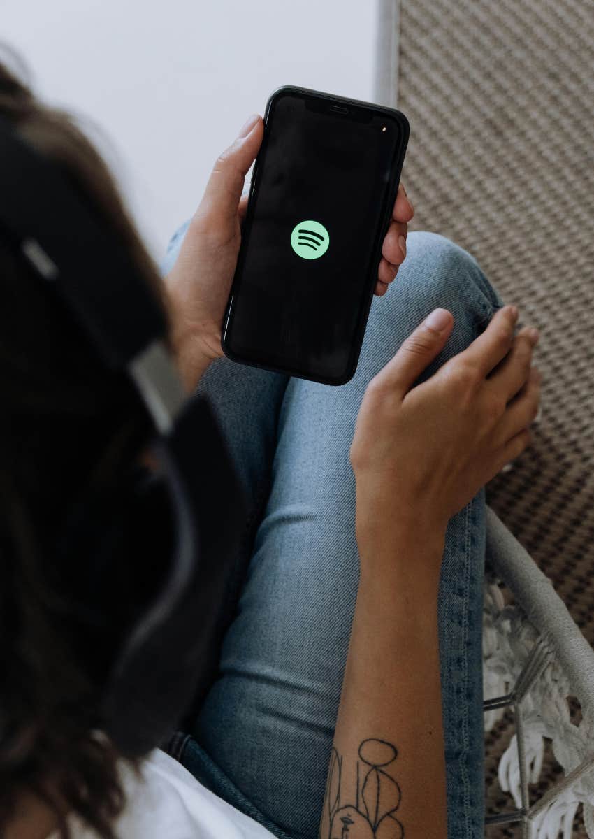 woman holding phone with Spotify