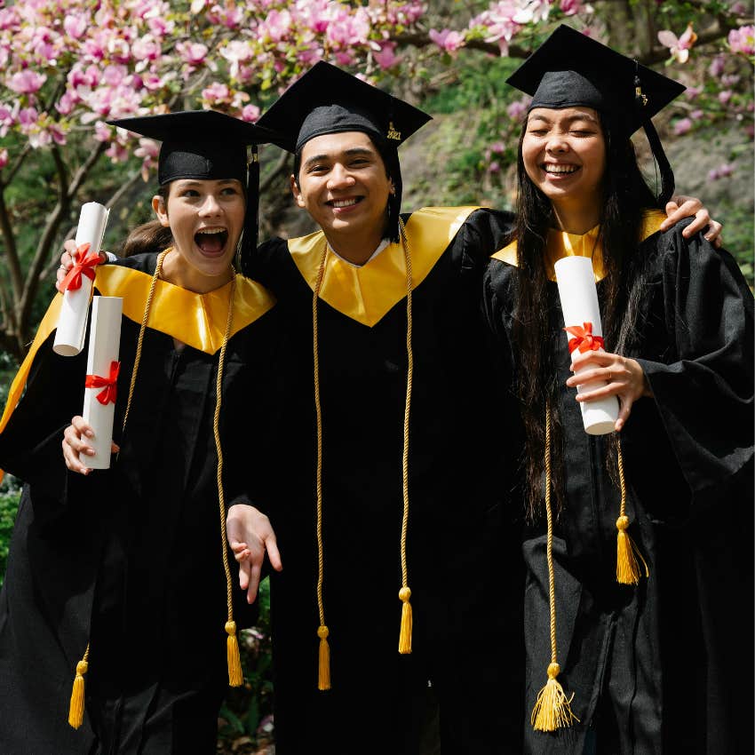 three students graduating