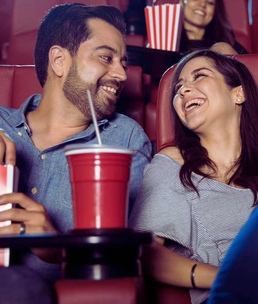 couple on a date at the movies laughing
