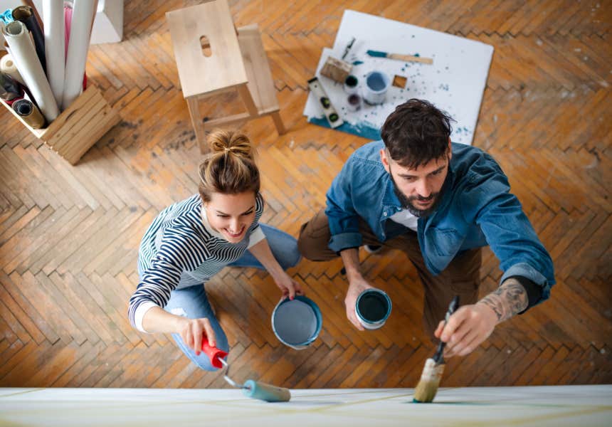 couple repaints a wall of their home