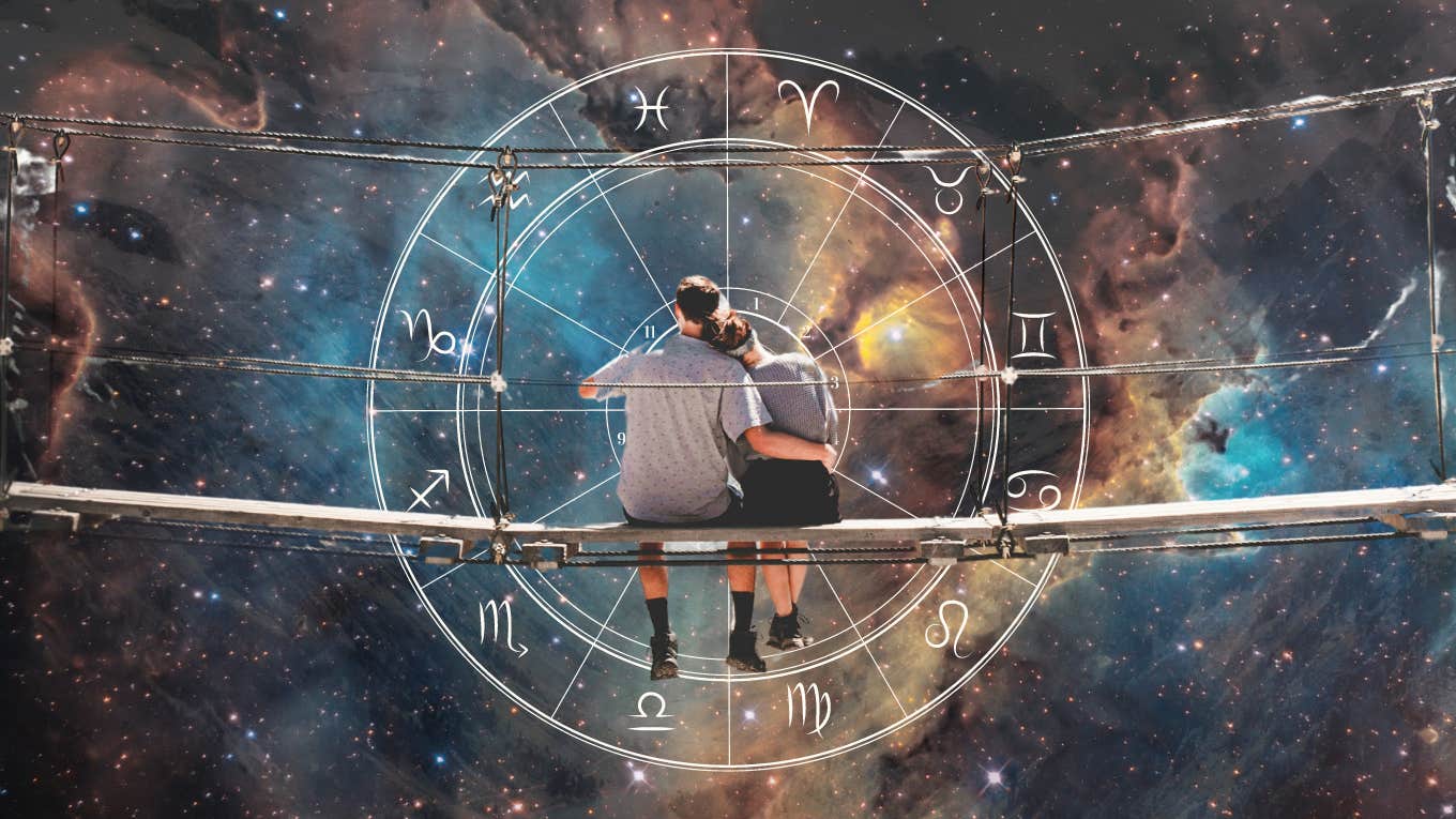 couple sitting in galaxy with zodiac wheel