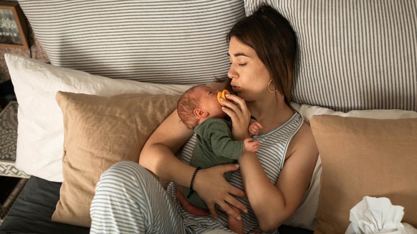 new mom lying on bed with baby