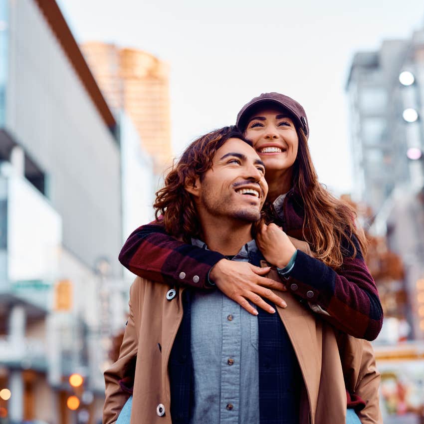 happy couple piggybacking and having fun together in the city.