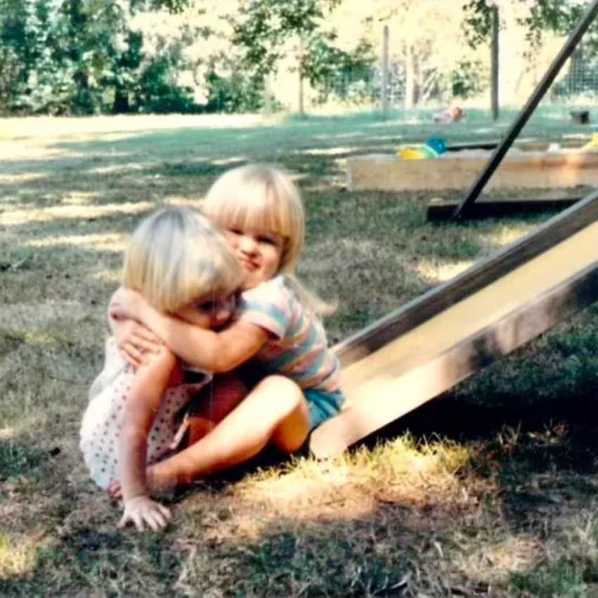 Kids hugging on slide