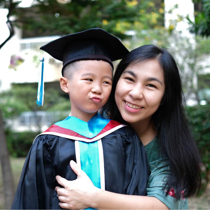 Mom smiling with little boy at his graduation. 