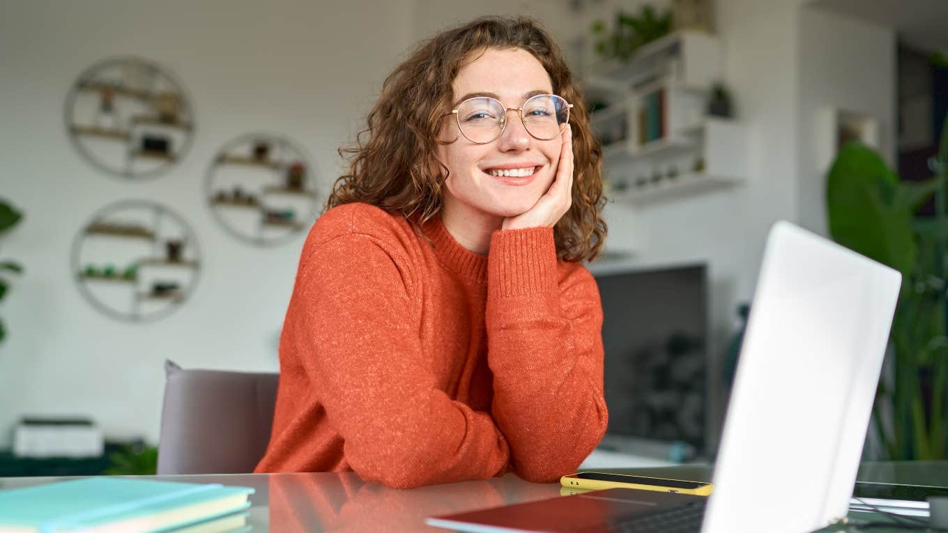 woman working on laptop and smiling
