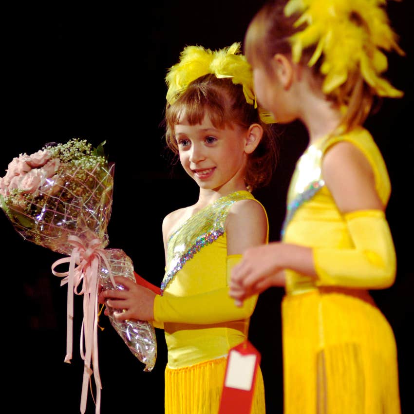 little girls in yellow dance costumes